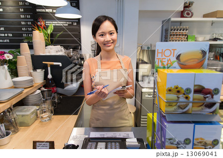 Smiling waitress at the counter 13069041
