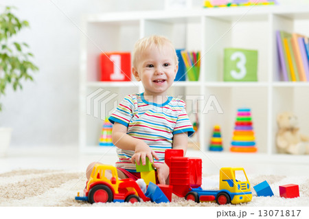 kid toddler playing with toy car 13071817