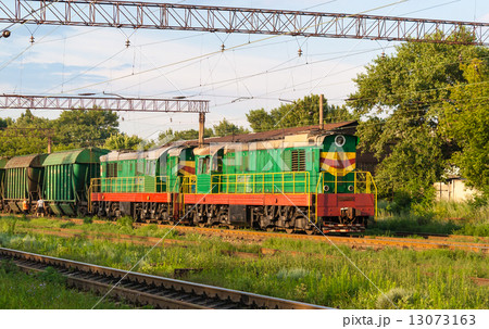 Two shunters with freight train at a station Two shunters with freight train at a station 13073163