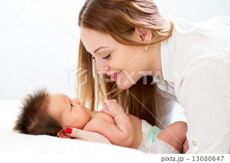 Happy mother cuddling her newborn baby Happy mother cuddling her newborn baby 13080647