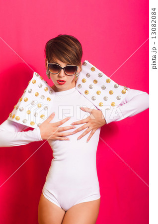 Beautiful girl in a white concert suit on pink background 13082084