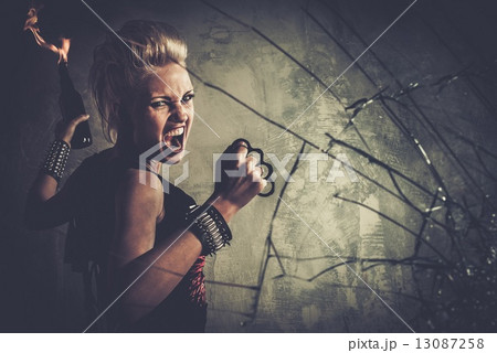 Punk girl with brass knuckles and Molotov cocktail 13087258