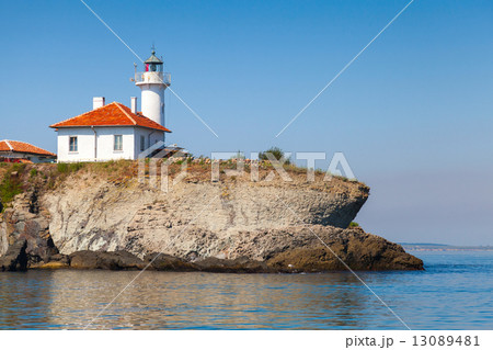 White lighthouse with red light on St. Anastasia Island 13089481