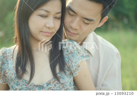 chinese young couple embracing each other on meadow chinese young couple embracing each other on meadow 13093210