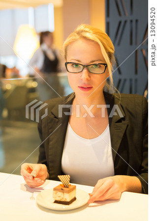 Women eating dessert in fancy restaurant. 13094520