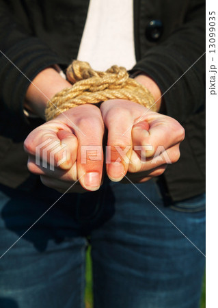 Hands tied up with rope Hands tied up with rope 13099035