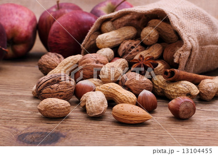 Nuts in jute sack cinnamon sticks, star anise 13104455