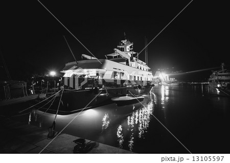 Monochrome photo of luxurious private yacht moored at pier at ni 13105597