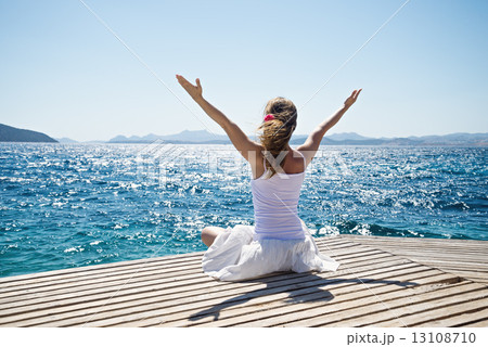 Woman meditating at the sea 13108710