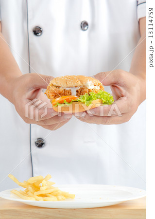 chef holding fried chicken burger chef holding fried chicken burger 13114759