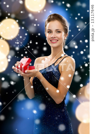 smiling woman holding red gift box smiling woman holding red gift box 13117646