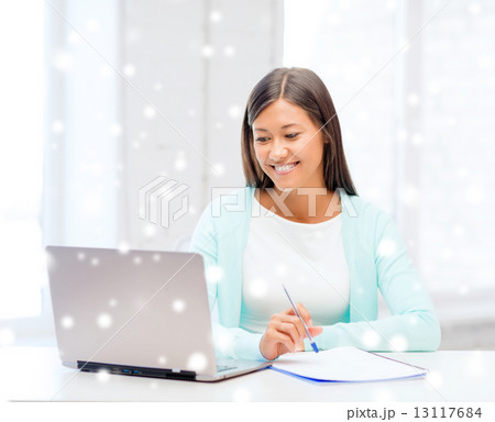 smiling young woman with laptop and notebook 13117684