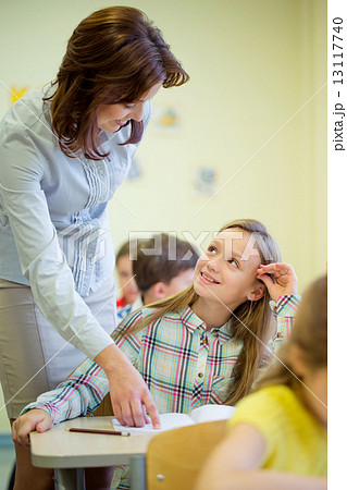 group of school kids writing test in classroom 13117740