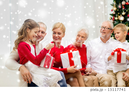 smiling family with gifts at home 13117741