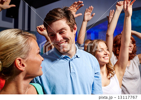 smiling friends at concert in club 13117767