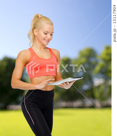 smiling sporty woman with tablet pc computer smiling sporty woman with tablet pc computer 13117904