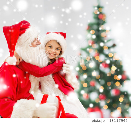 smiling girl with santa claus and gift at home smiling girl with santa claus and gift at home 13117942