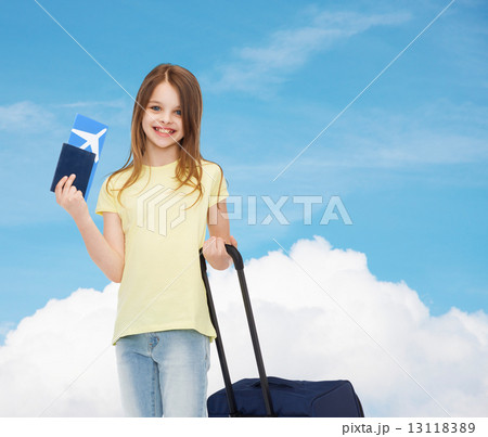 smiling girl with suitcase, ticket and passport 13118389