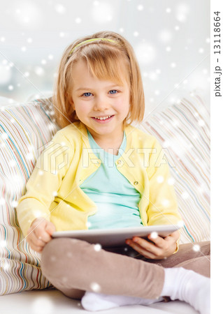 smiling girl with tablet pc computer at home 13118664