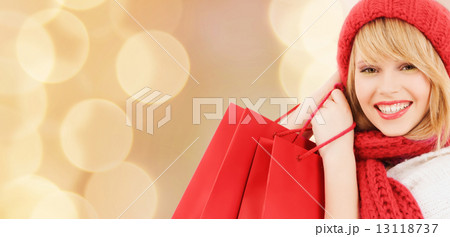 smiling young woman with shopping bags 13118737