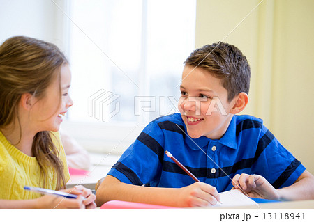group of school kids writing test in classroom 13118941