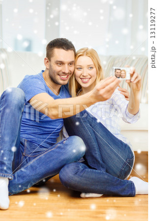 smiling couple taking picture with digital camera 13119277
