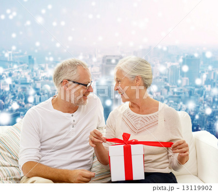 happy senior couple with gift box at home happy senior couple with gift box at home 13119902