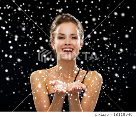 laughing woman in evening dress holding something 13119946