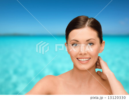 smiling young woman with bare shoulders 13120330