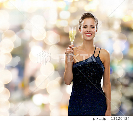 smiling woman holding glass of sparkling wine smiling woman holding glass of sparkling wine 13120484