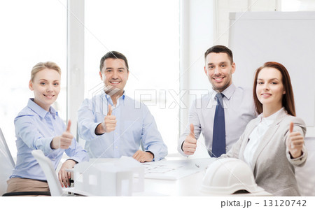 happy team of architects and designers in office 13120742
