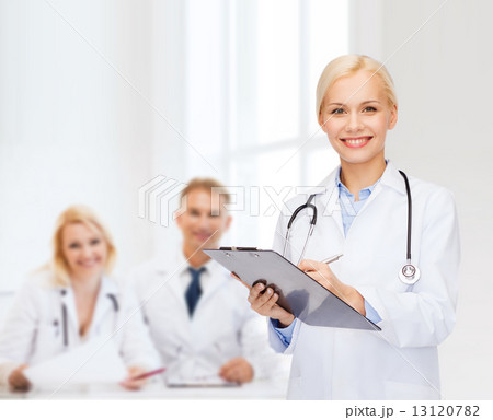smiling female doctor with clipboard smiling female doctor with clipboard 13120782