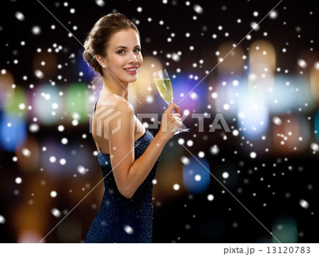smiling woman holding glass of sparkling wine smiling woman holding glass of sparkling wine 13120783