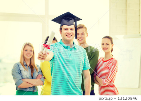 smiling male student with diploma and corner-cap 13120846