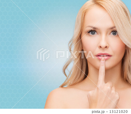 beutiful young woman touching her lips beutiful young woman touching her lips 13121020