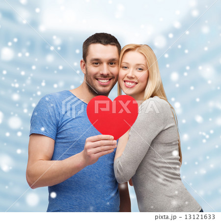 happy couple with red heart shape hugging outdoors happy couple with red heart shape hugging outdoors 13121633