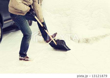 closeup of man shoveling snow from driveway closeup of man shoveling snow from driveway 13121879