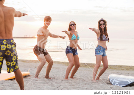 smiling friends in sunglasses with surfs on beach smiling friends in sunglasses with surfs on beach 13121932