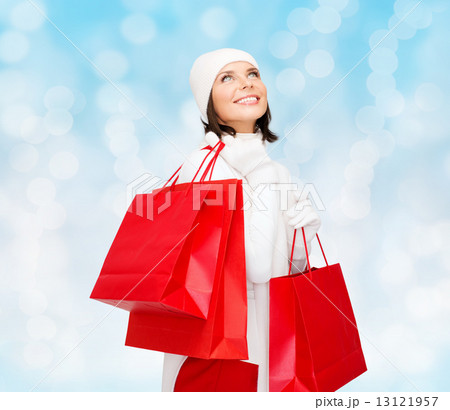 smiling young woman with red shopping bags 13121957