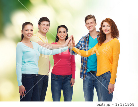 group of smiling teenagers over green background 13121959