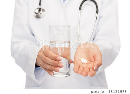 close up of doctor offering pills and water 13121973