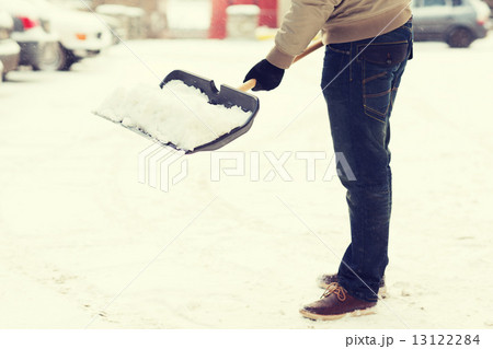 closeup of man shoveling snow from driveway closeup of man shoveling snow from driveway 13122284