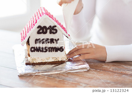 close up of woman making gingerbread houses close up of woman making gingerbread houses 13122324