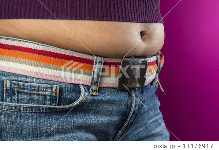 Woman with jeans shows her belly. Woman with jeans shows her belly. 13126917