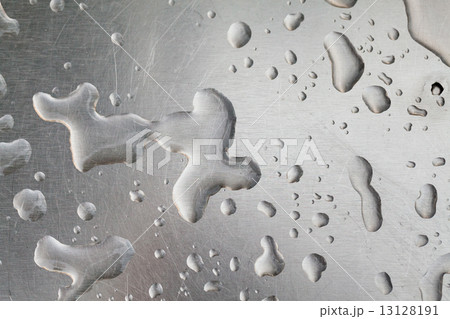 Metal surface covered in water drops. 13128191