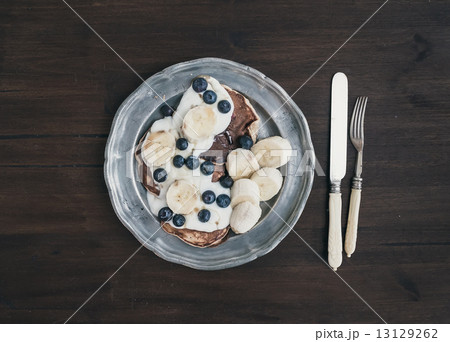 Breakfast set on dark wooden desk Breakfast set on dark wooden desk 13129262