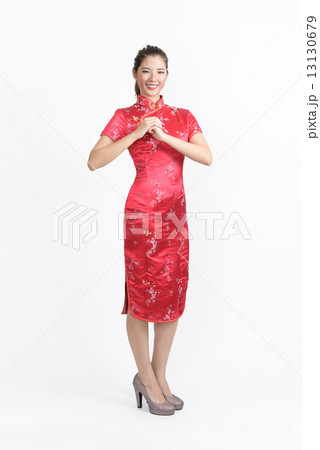 One young chinese woman in Cheongsam wishing you abundance of wealth in isolated white background One young chinese woman in Cheongsam wishing you abundance of wealth in isolated white background 13130679
