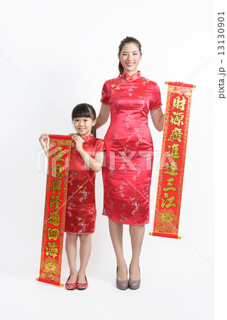 Mother daughter in Cheongsam with banners wishing good business fortune isolated white background  Mother daughter in Cheongsam with banners wishing good business fortune isolated white background  13130901