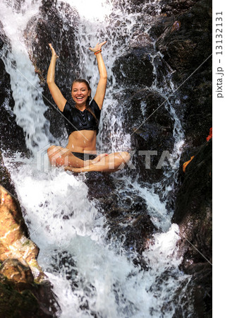 Young woman enjoying in natural tropical Waterfall Young woman enjoying in natural tropical Waterfall 13132131