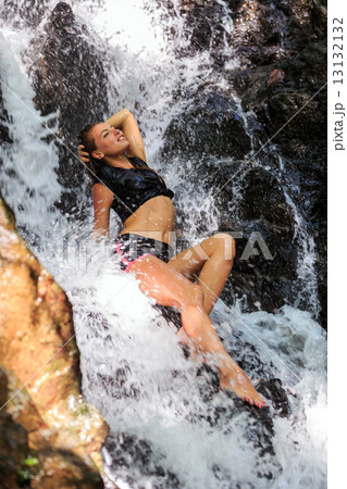 Young woman enjoying waterfall freshness Young woman enjoying waterfall freshness 13132132